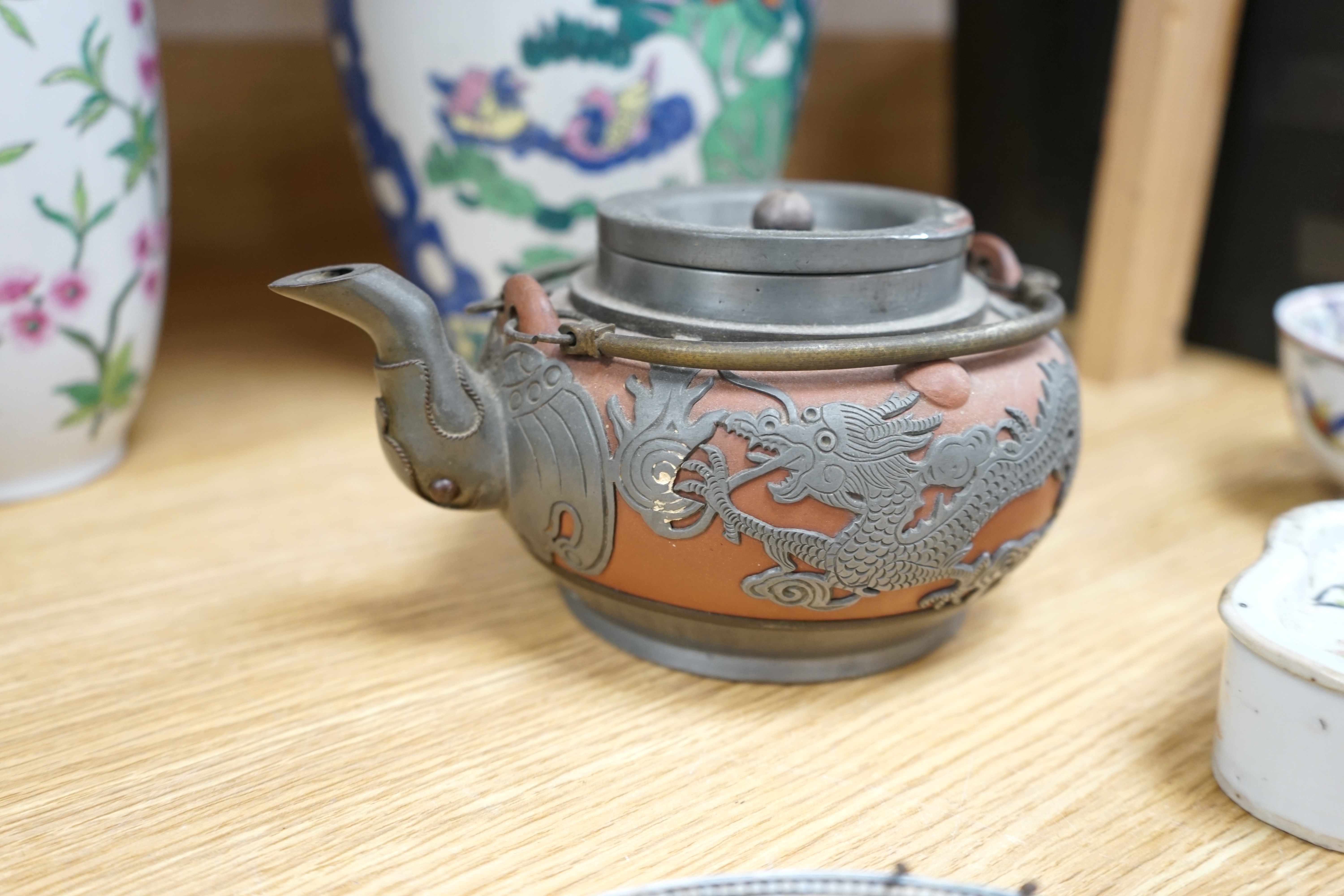 A collection of Chinese ceramics to include and bowls, plates, pottery dragon teapot and a green glaze water carrier, largest 31cm high. Condition - mostly fair